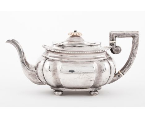 Regency style silver teapot, Nathan & Hayes, Chester 1898, of squat lightly lobed oblong form, gadrooned rim, flat top scroll