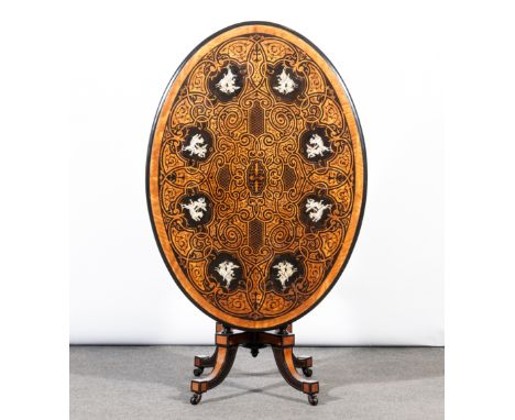 Victorian maple ebonised and inlaid ivory loo table, oval top with a moulded edge, top with inlaid tracery and winged cherubs