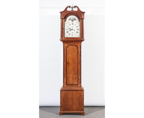 Oak longcase clock, swan neck pediment centred by a brass finial, turned and fluted columns, long door with mahogany cross-ba