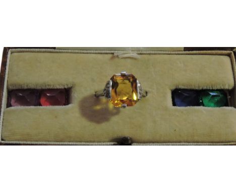 An Art Deco style silver inter-changeable gem pace set ring, simulating sapphire, ruby, emerald, amethyst and topaz, cased.
