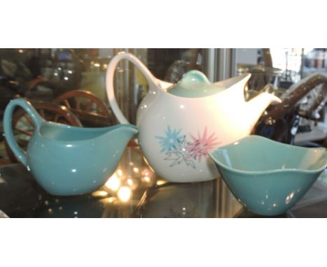 A Midwinter Stylecraft Duo tea service, comprising teapot, milk jug and sugar bowl.