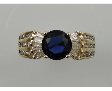 A sapphire and diamond dress ring, in a yellow metal band, 5.8g. 