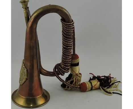 A copper and brass bugle, bearing the regimental arms of the Argyle & Sutherland Highlanders.