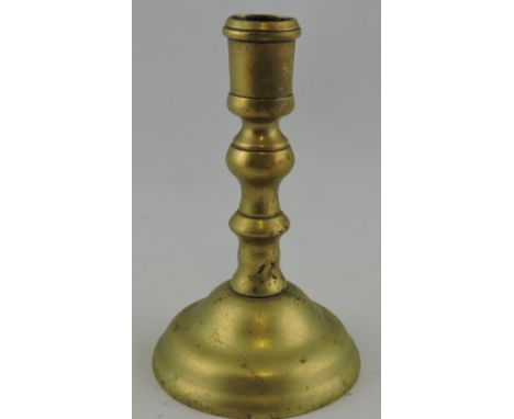 A 19th century dwarf brass candlestick, turned support with a domed base, H. 14cm.