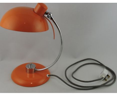 A retro style table lamp, the orange metal domed shade and circular base with a chrome support, H. 35cm.