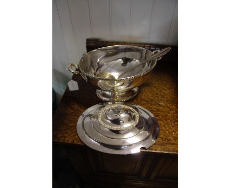 A silver-plated oval tureen, the lid with an acorn knop, with gadroon border and two handles, together with a ladle, W. 37cm.