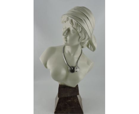 A ceramic bust of young girl, raised on a mottled brown plinth, H. 56cm.