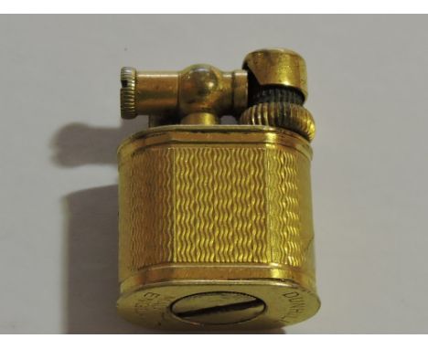 A Dunhill 'Baby Sylph' miniature petrol lighter, circa.  1950 with gold plated engine turned body