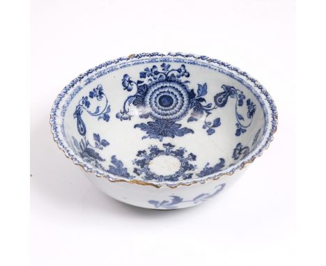 AN 18TH CENTURY ENGLISH DELFTWARE BOWL decorated in cobalt blue with flowers and with frill edge 27cm diameter x 10cm high (c