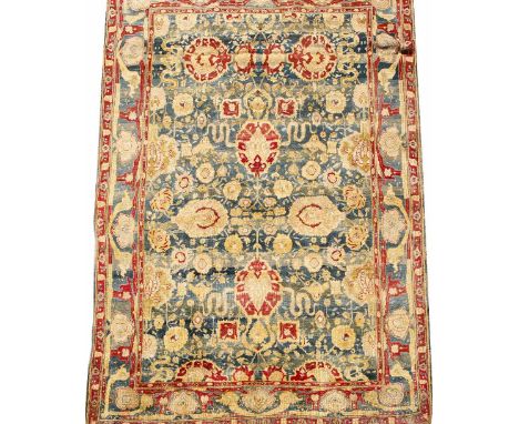 AN EARLY TO MID 20TH CENTURY INDIAN BLUE AND RED GROUND SMALL CARPET  with a banded border and stylised foliate decoration, 3