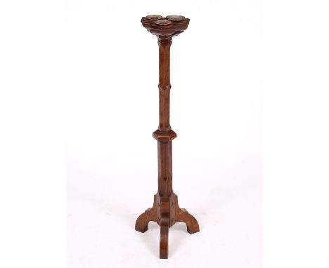 AN ARTS & CRAFTS COTSWOLD SCHOOL CANDLESTICK  with three sconces to the top, carved hexagonal stem and tripod base 69cm high 