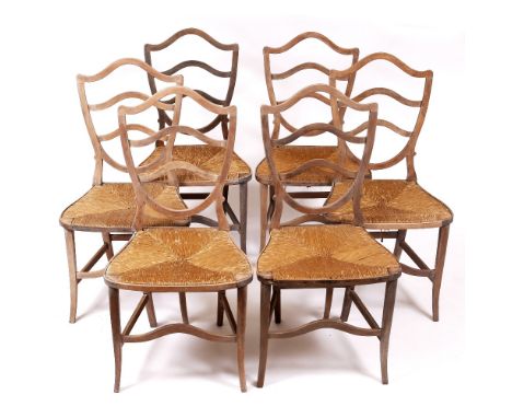 A SET OF SIX LIMED BEECHWOOD KITCHEN CHAIRS with shield shaped ladder backs, rush seats and square tapering legs, 49cm wide x