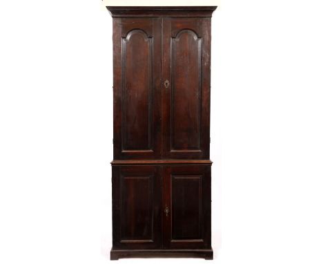 A LARGE MID 18TH CENTURY OAK ESTATE CABINET with fielded panelled doors, carrying handles to the side, all standing on bracke