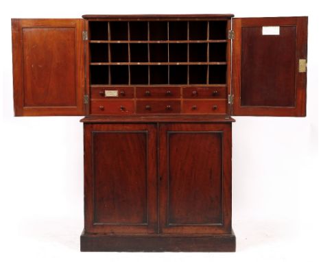 AN EARLY VICTORIAN MAHOGANY SOLICITORS CABINET with four panelled doors, the upper section enclosing pigeon holes and drawers