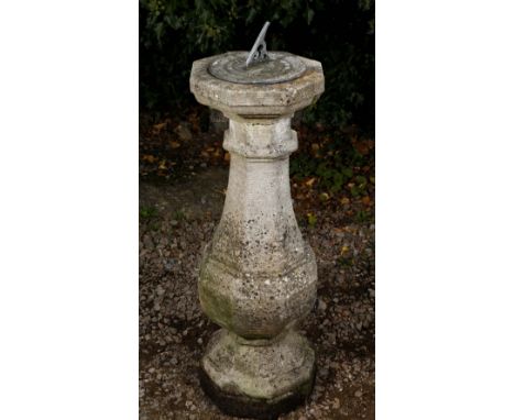 AN OCTAGONAL GEORGIAN STYLE RECONSTITUTED STONE SUN DIAL of baluster form with lead sundial plate and gnomen, 122cm high over