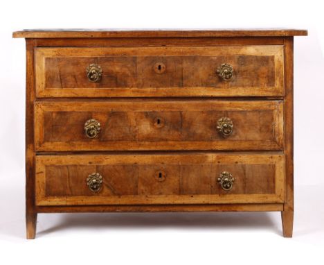 AN 18TH CENTURY ITALIAN WALNUT COMMODE with crossbanded top and fitted with three long drawers with ornate brass ring handles
