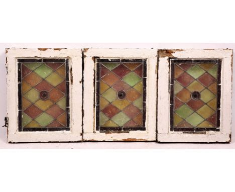 A GROUP OF THREE STAINED GLASS FAN LIGHT WINDOWS in white painted frames, the frames 50cm x 39.5cm (3)
