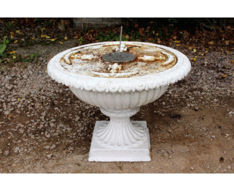 A WHITE PAINTED CAST IRON URN of shallow campana form, transformed for use as a sundial with central sundial plate 75cm diame