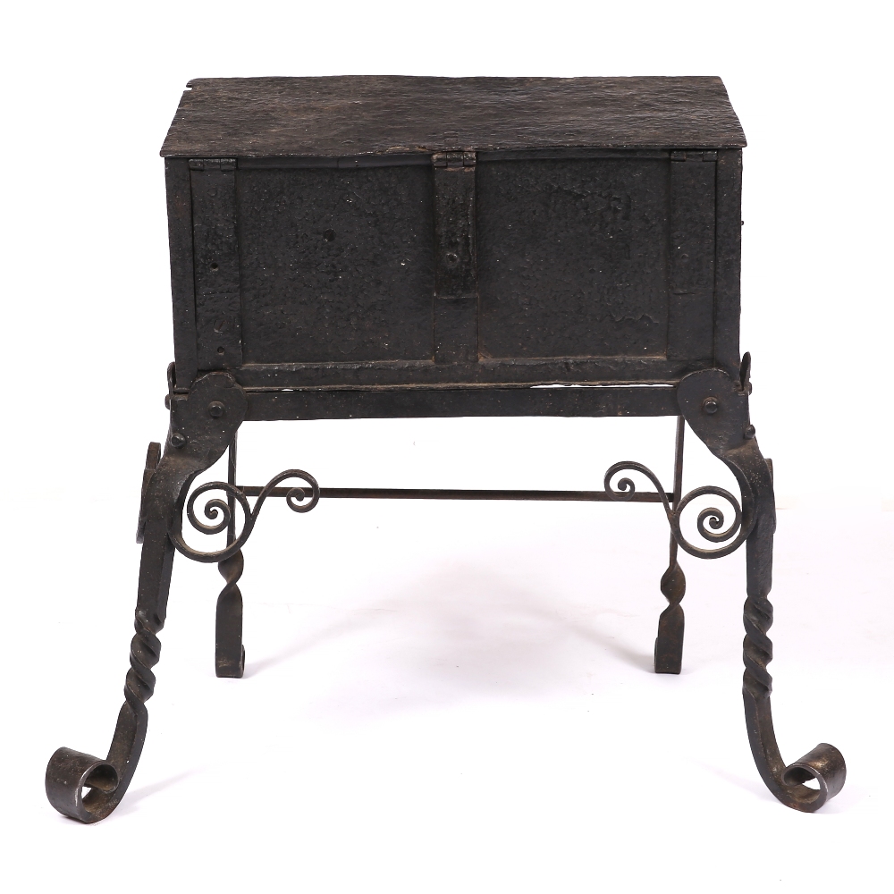 AN 18TH CENTURY IRON STRONG BOX with panelled sides and with ornate