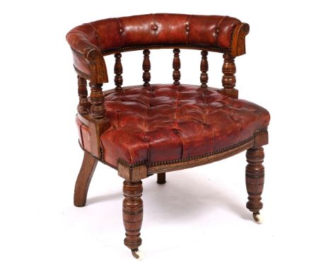 A LATE 19TH / EARLY 20TH CENTURY OAK FRAMED BUTTON UPHOLSTERED RED LEATHER TUB CHAIR  with turned fore legs and ceramic caste