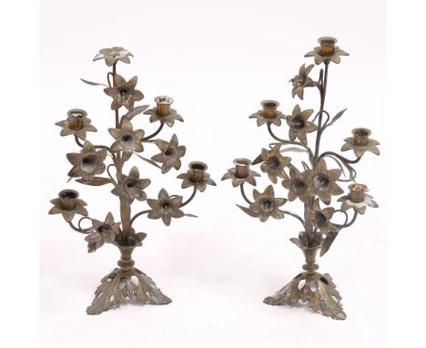 A PAIR OF CAST AND WROUGHT BRASS FIVE LIGHT CANDELABRA moulded in the form of lily stems on a leaf moulded tripod base, each 