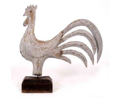 AN OLD PAINTED TIN COCKEREL WEATHER VANE  now on a later wooden plinth base, the cockerel 79cm wide x 67cm high 