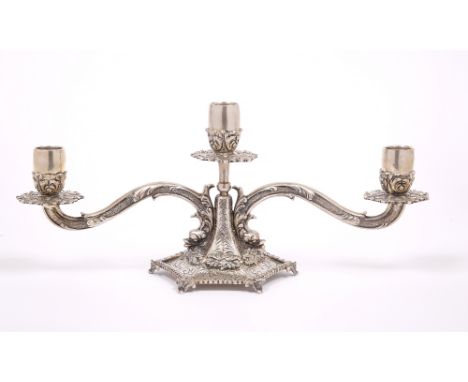 AN ITALIAN WHITE METAL TWO BRANCH THREE LIGHT CANDELABRUM with acanthus leaf decoration and dolphin head masks to the termina