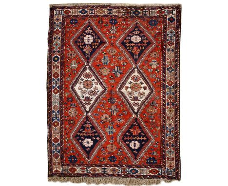 A SOUMAK RED GROUND CARPET with two rows of three diamond motifs, a banded border and geometric polychrome decoration 280cm x