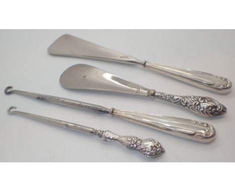Two pairs of silver handled button hooks and shoe horns