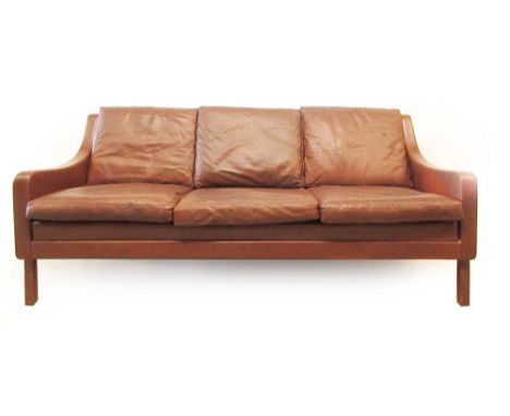 A 1970's wine coloured three seater sofa on mahogany feet