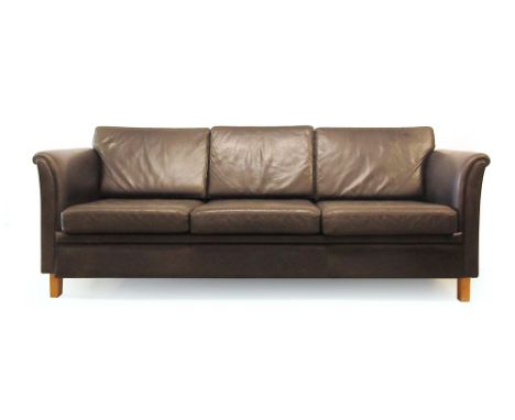 A 1970's black leather three seater sofa on beech legs with open arms