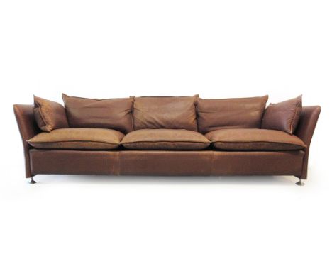 A 1970's brown leather three seater sofa with loose cushions on chromed feet and castors CONDITION REPORT: Length 229 cm. Dep