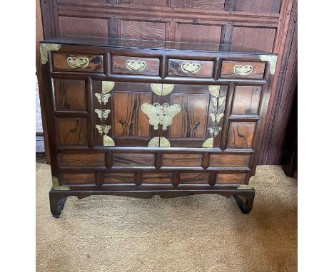 Near pair of Chinese hardwood brass mounted cabinets with an arrangement of drawers and cupboards, butterfly formed hinges, r