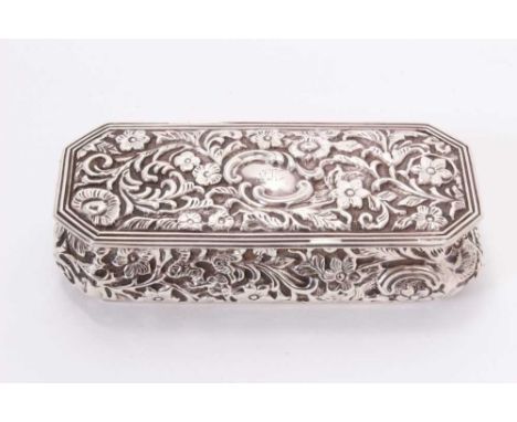 Edwardian silver trinket box of rectangular form with repoussé floral decoration, octagonal hinged cover and silver gilt inte