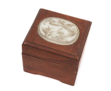 Chinese hardwood box inset with oval carved jade or celadon hardstone plaque, carved in low relief with mythical beasts and f