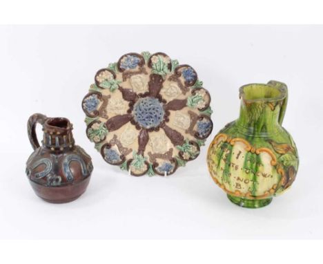 A Castle Hedingham pottery dish decorated in relief with portrait medallions, together with a Hedingham jug with horseshoes a