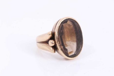 Antique 9ct gold and smokey quartz signet ring with a large oval mixed cut smokey quartz in rub-over setting on heavy 9ct gol