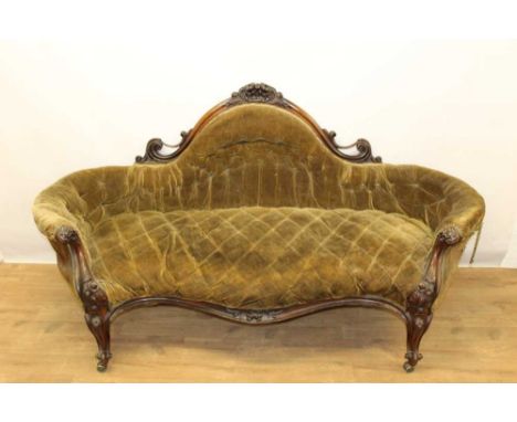 Victorian mahogany and velvet button upholstered sofa, with ornate arched back and foliate carved showwood frame on carved ca