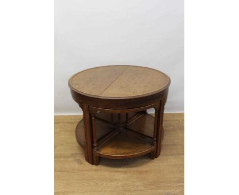 1930s oak circular nest of coffee tables, circular dish top table on square supports, 70cm diameter, housing four side tables