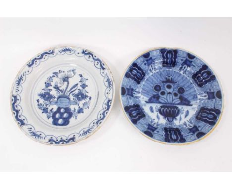 Two 18th century blue and white Dutch delftware dishes, one painted with the Peacock pattern, the other with flowers, 34.5cm 