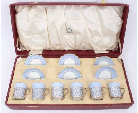 Set of six Aynsley blue coffee cans in pierced silver cup mounts (Sheffield 1917) and six matching saucers, in fitted cased r