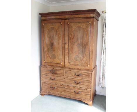 19th century inlaid mahogany linen press, the dentil cornice above twin inlaid panelled doors enclosing five slides, above tw