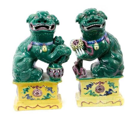 Pair Chinese Kangxi style polychrome dogs of foo, standing 23cm high