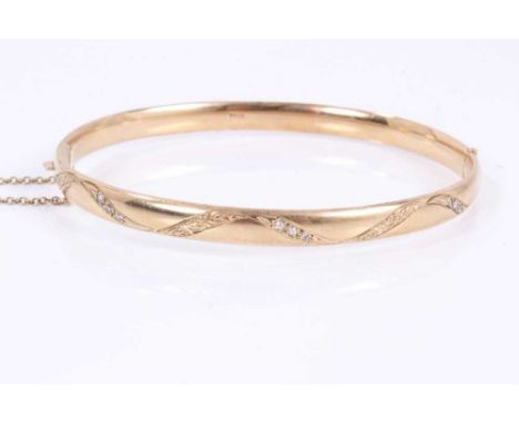 9ct gold hinged bangle set with diamonds and engraved decoration.Gross weight approximately 19.75 grams.