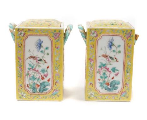 A pair of Chinese porcelain pot pourri vases, circa 1900, decorated with panels of birds and flowers on a yellow floral-patte