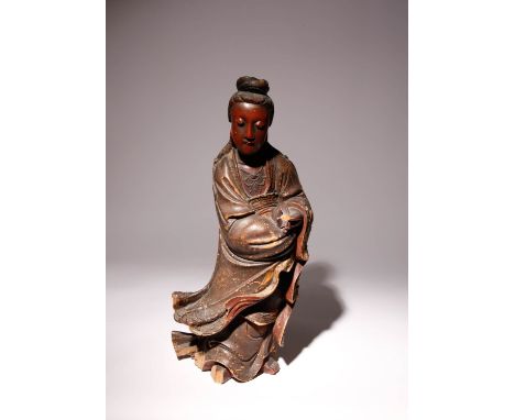 A CHINESE CARVED AND LACQUERED WOOD FIGURE OF GUANYIN QING DYNASTY Standing, wearing long flowing robes and beaded necklaces,