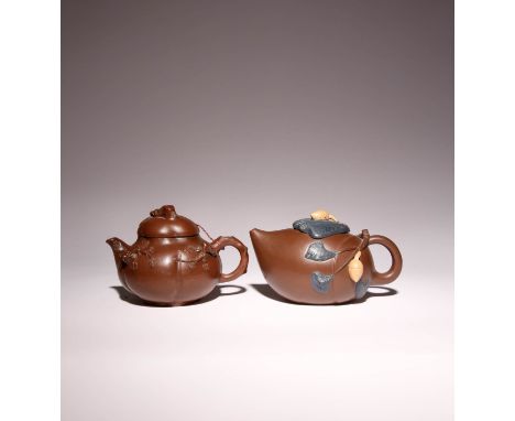 TWO CHINESE YIXING TEAPOTS AND COVERS 20TH CENTURY One decorated with ginkgo nuts and branches to the ovoid body, the base wi