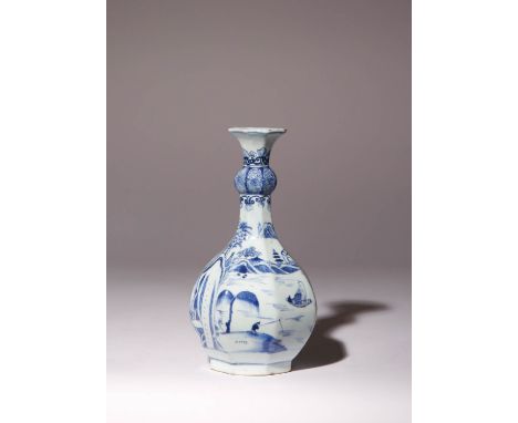 A CHINESE BLUE AND WHITE OCTAGONAL BOTTLE VASE KANGXI 1662-1722 Painted with a continuous watery landscape scene with pagodas