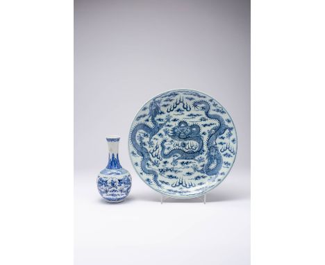 A CHINESE BLUE AND WHITE 'DRAGON' DISH AND A BOTTLE VASE LATE QING DYNASTY Each piece painted with scaly dragons, flaming pea