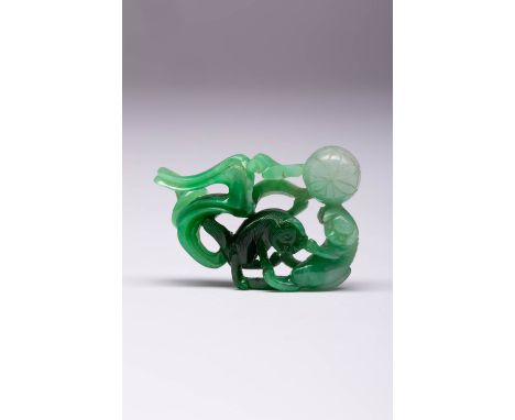 A CHINESE APPLE-GREEN JADEITE PENDANT 20TH CENTURY Depicting two Buddhist lion dogs and a ribbon tied brocade ball with a sin